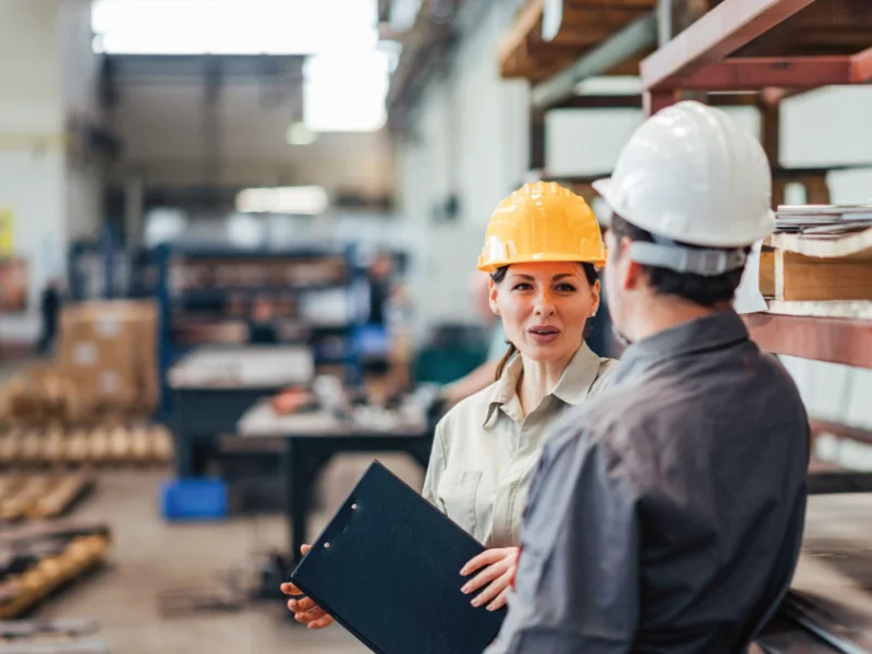 Safety professional documenting workplace hazards during a facility safety audit